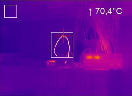 Thermal image of a hot wire connecting electrical devices.